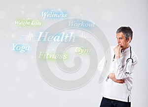 Clinical doctor pointing to health and fitness collection of words