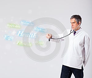 Clinical doctor pointing to health and fitness collection of words