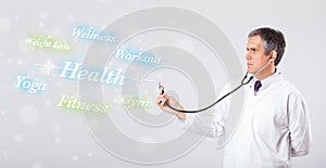 Clinical doctor pointing to health and fitness collection of words