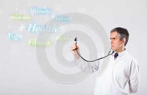 Clinical doctor pointing to health and fitness collection of words