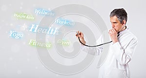 Clinical doctor pointing to health and fitness collection of words