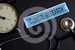 Clinical Research on the print paper with Healthcare Concept Inspiration. alarm clock, Black stethoscope.