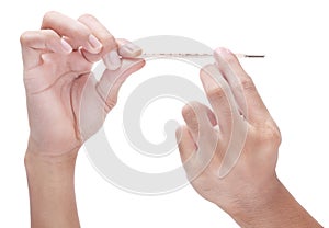 Clinical thermometer between fingertips photo