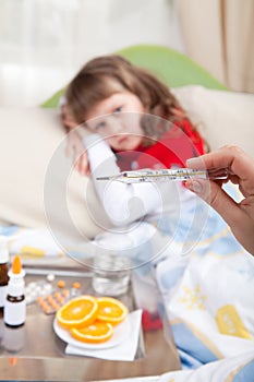 Clinical thermometer in hand showing fever