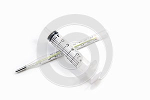 Clinical thermometer and a syringe