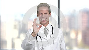 Clinician doctor man showing ok sign.