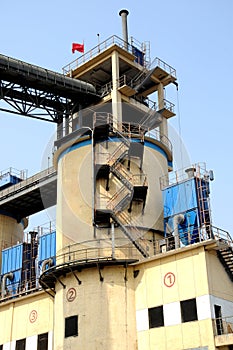 Clinker storage building with light yellow color in a cement factory photo