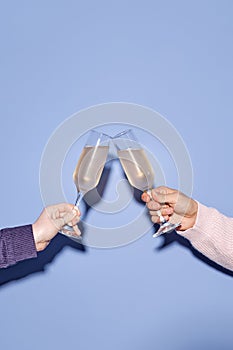 Clinking Glasses in Celebration with Blue Background photo