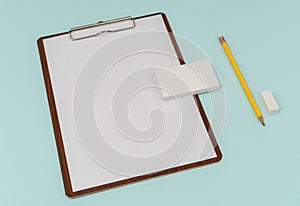 Clip board, paper,pencil and business card on blue background .