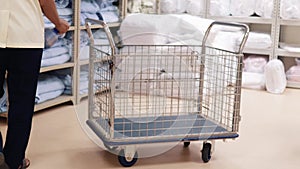 Clip of health worker sanitize bulk trolley at the linen store