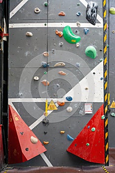 Clip In Warning Sign Before Climbing next to a Rope clipped in an Anchor on a Wall in an Indoor Climbing Hall