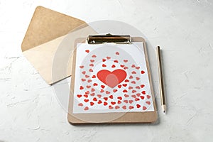 Clipboard with blank paper, red paper hearts