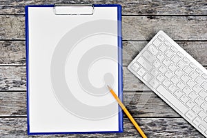 Clipboard with blank white paper with pen and keyboard computer