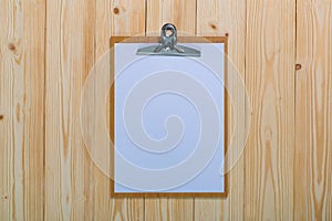 clipboard with blank white paper sheet on wood table top view wi