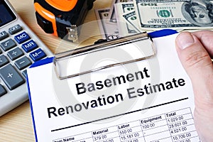 Clipboard with calculations basement renovation estimate. Remode
