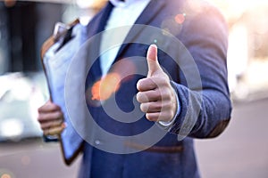 Clipboard, checklist and thumbs up from inspector with hands to show compliance, approval or ok sign. Yes, agreement and