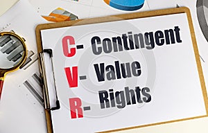 Clipboard with contingent value rights CVR text on financial documents and magnifying glass