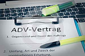 Clipboard with a contract and inscription in german ADV-Vertrag in english ADV contract and subject matter and duration of the con