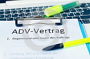 Clipboard with a contract and inscription in german ADV-Vertrag in english ADV contract and subject matter and duration of the con