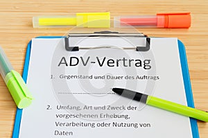 Clipboard with a contract and inscription in german ADV-Vertrag in english ADV contract and subject matter and duration of the con