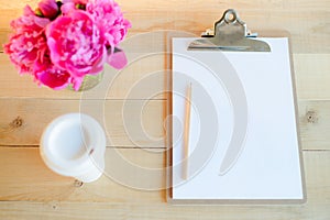 Clipboard, cup and flowers