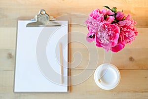 Clipboard, cup and flowers