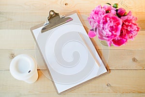 Clipboard, cup and flowers