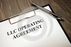 Clipboard with llc operating agreement and pen on desk