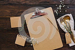 Clipboard mock up with vintage cutlery and wedding flowers. Planning concept.