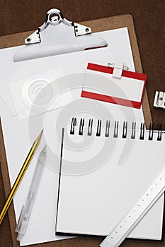 Clipboard notepad pencil and other office equipment arranged in studio