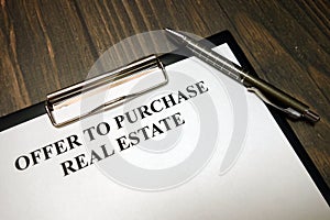 Clipboard with offer to purchase real estate mockup and pen on desk