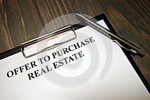 Clipboard with offer to purchase real estate mockup and pen on desk photo