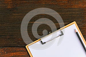 clipboard and pen on old wood table