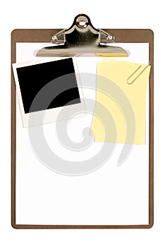 Clipboard with polaroid photo frame and yellow post-it style sticky note, isolated on white background, copy space