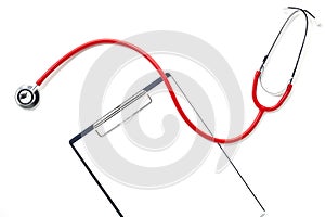 clipboard with red stethoscope and pen