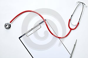 clipboard with red stethoscope and pen