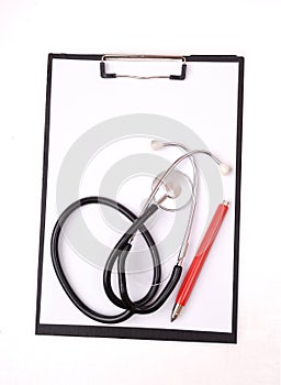 Clipboard, stethoscope and red pen