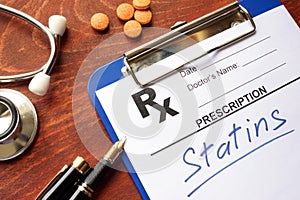 Clipboard with written prescription statins. photo