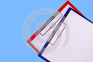 Clipboards isolated on a simple blue background photo