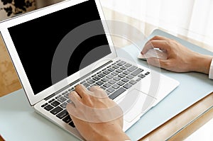 Clipping Path Businessman working on modern office. Closeup hands using contemporary notebook with blank monitor, texting