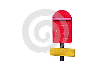 Clipping path, old red wooden mailbox on black pillar with blank yellow wooden sign isolated on white background, copy space