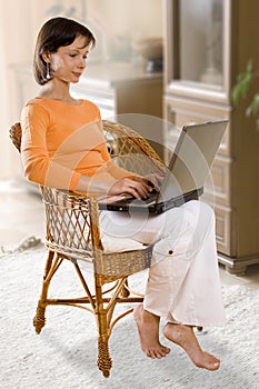 CLIPPING PATH! Woman with laptop on the chair