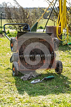 Clleaning a lawn thatcher in the garden