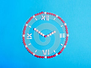 Clock with arrows from medical tablets and pills. Health concept