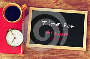 Clock, coffee cup and blackboard with the phrase time for change