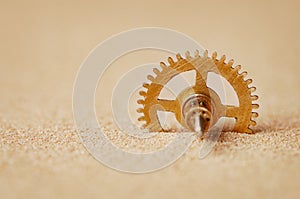 Clock detail - a gear in the sand