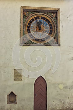 Clock And A Door On An Old Church Wall