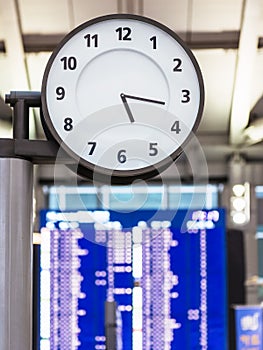 Clock face and Flight Timetable at Station Airport travel Concept