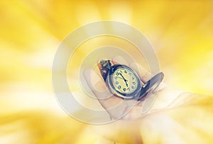 Clock on hand and blank space area yellow golden background