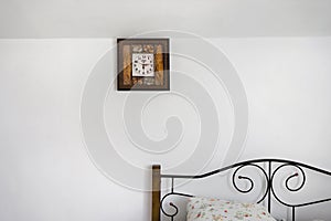 Clock hanging on a white wall in countryhouse